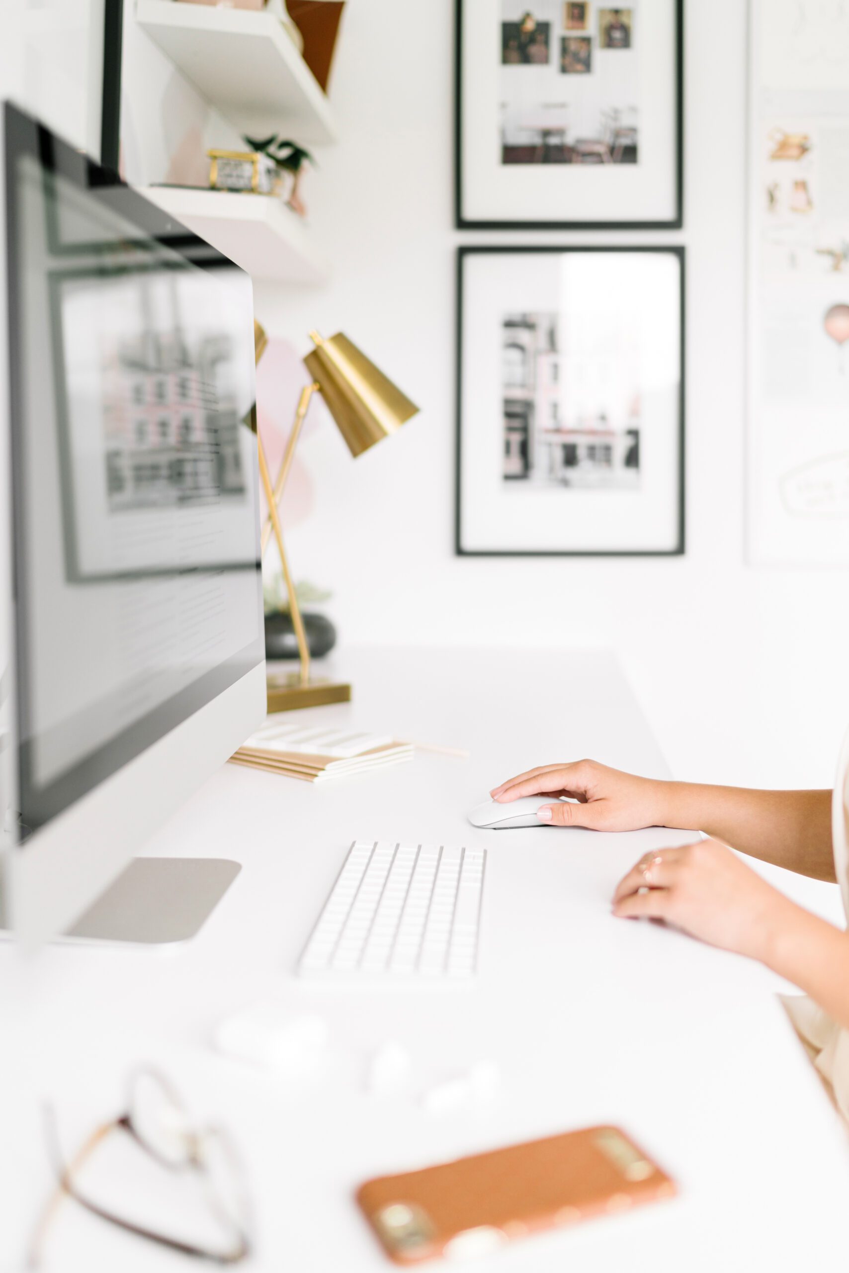 A woman's hands on her desktop's keyboard in her home office
